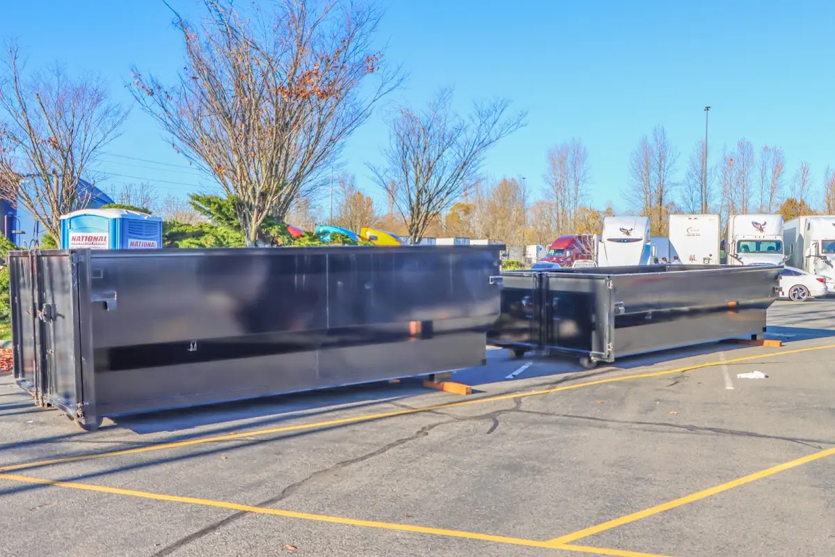Professional dumpster rental service with roll-off container on residential driveway in Pacifica